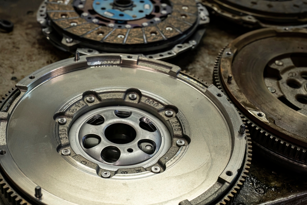 Dual mass flywheel and clutch components on a workshop bench